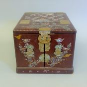 A Chinese mother-of-pearl lacquered travelling box. 28 cm wide.