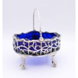 A Georgian silver basket salt with blue glass liner. 6 cm high. 92.3 grammes.