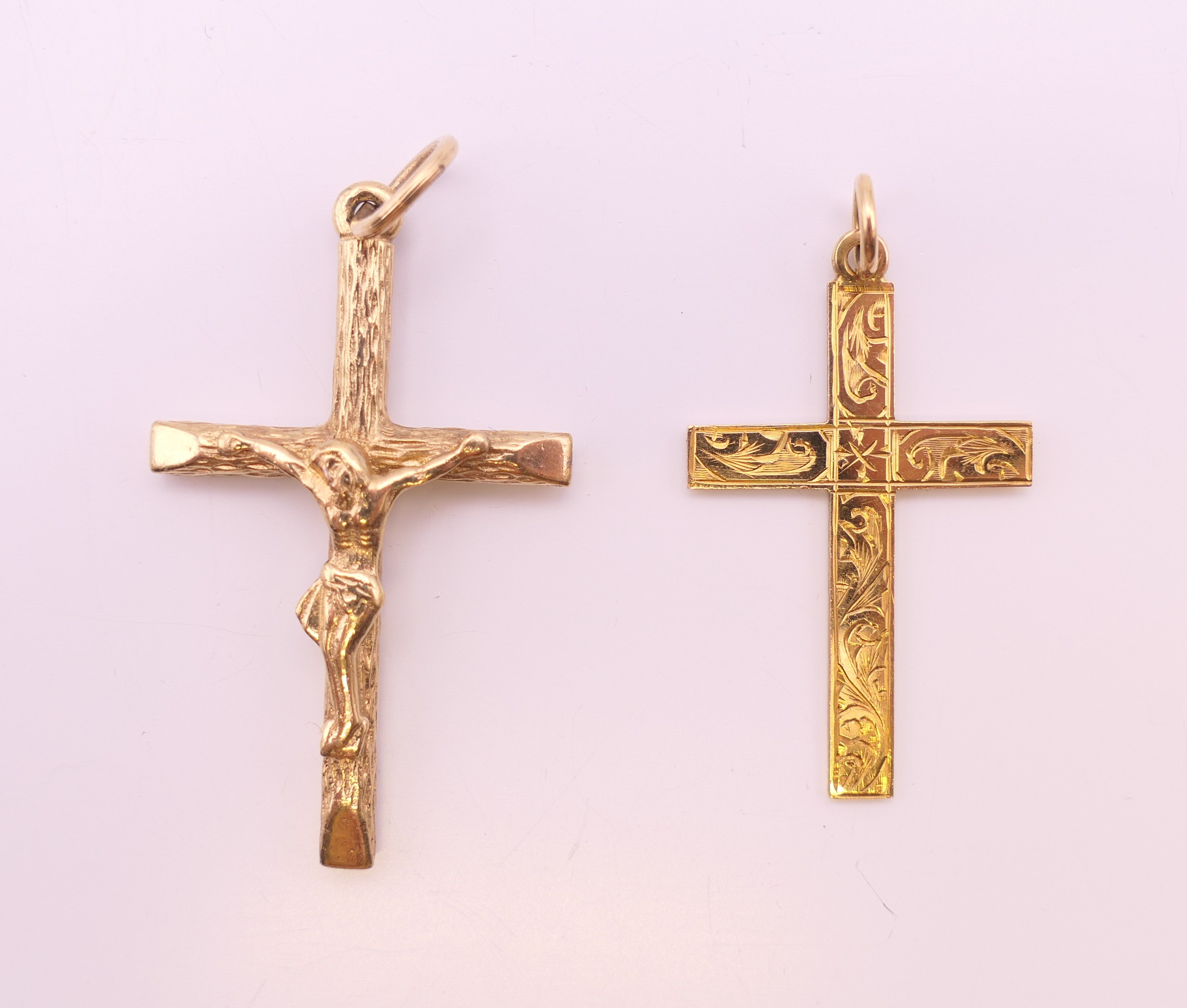 Two 9 ct gold cross/crucifix pendants. The largest 3.5 cm high. 6.2 grammes.