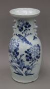 A 19th century Chinese pale celadon porcelain vase painted in underglaze blue with a bird amongst