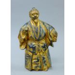 A Japanese gilt iron figure of a man. 26 cm high.