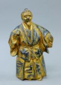 A Japanese gilt iron figure of a man. 26 cm high.