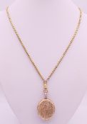 A gold plated locket on chain. Locket 3 cm high, chain 76 cm long.