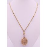 A gold plated locket on chain. Locket 3 cm high, chain 76 cm long.