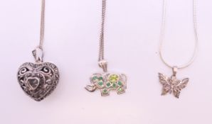 Three silver pendants (heart, elephant and butterfly) on silver chains. Elephant 2.5 x 1.