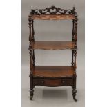 A Victorian rosewood three-tier whatnot. 56 cm wide.