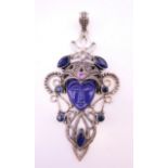 A silver pendant centred with a blue face. 10.5 cm high including suspension loop.