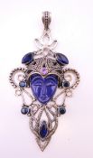 A silver pendant centred with a blue face. 10.5 cm high including suspension loop.