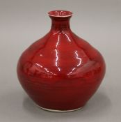 A red ground Studio Pottery vase, the underside indistinctly signed. 10.5 cm high.