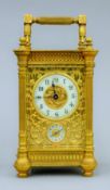 A 19th century gilt brass cased alarm carriage clock. 15.5 cm high.