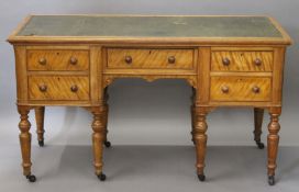 A Victorian satinwood desk. 134 x 57.5 cm.