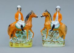 A pair of 19th century Staffordshire pottery models of fox hunters. 17.5 cm high.