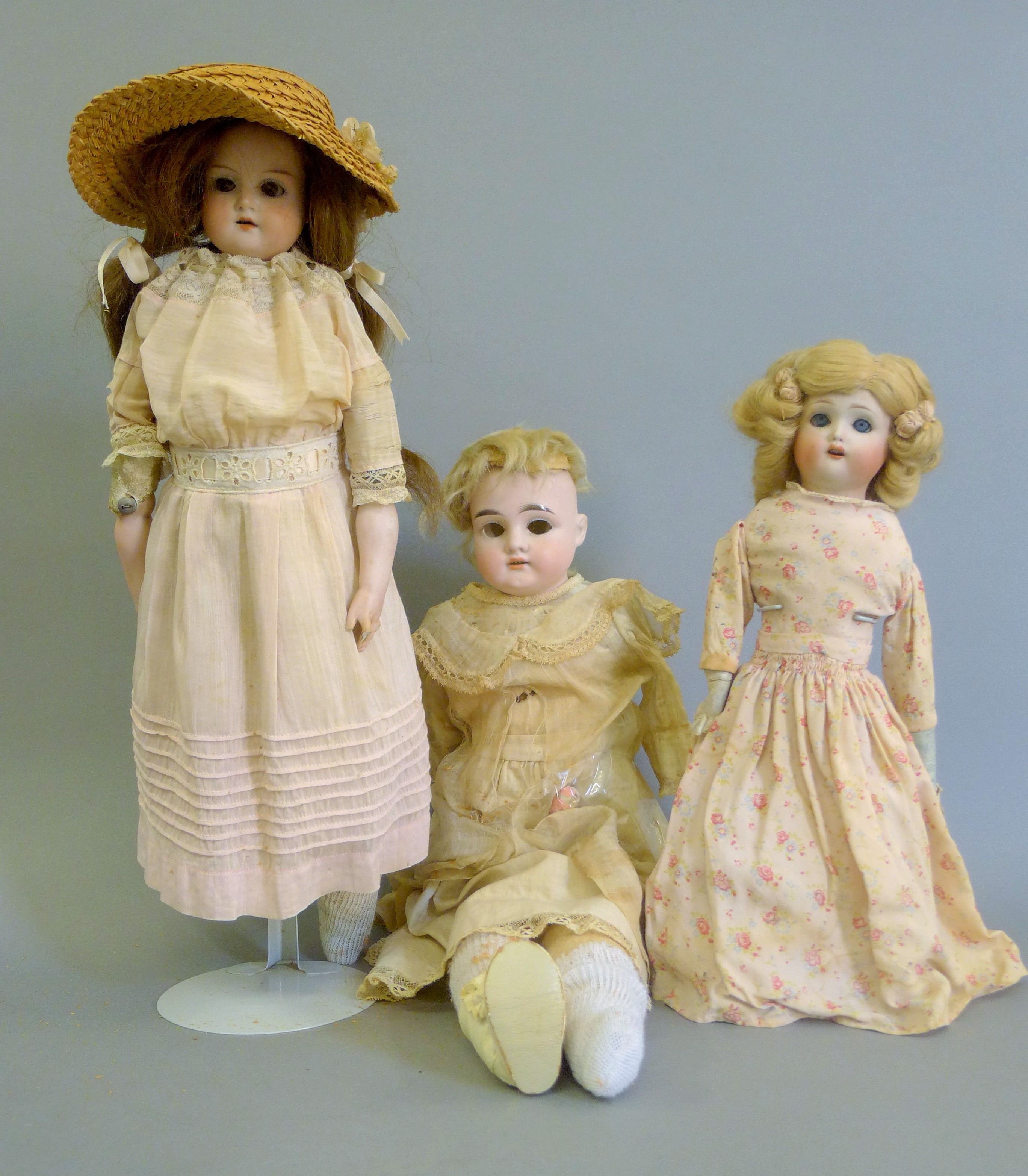 Three bisque headed dolls.