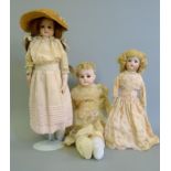 Three bisque headed dolls.