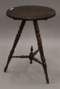 A 19th century mahogany gypsy table with turned bobbin legs and bobbin struts with central finial.