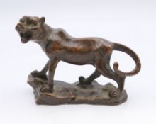 A bronze model of a tiger. 5.5 cm high, 6.5 cm long.