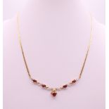 A 9 ct gold garnet and diamond necklace. Approximately 41 cm long. 6 grammes total weight.