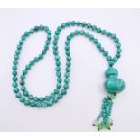 A string of turquoise beads. Beads 86 cm long, pendant 10 cm long.