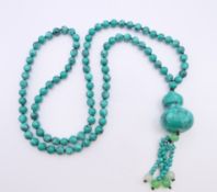 A string of turquoise beads. Beads 86 cm long, pendant 10 cm long.
