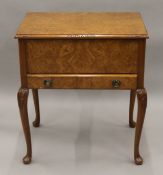 A 20th century walnut sewing box. 56 cm wide.