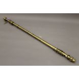 A brass curtain pole. Approximately 215 cm long.