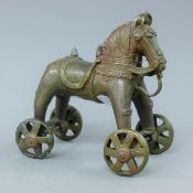 An Indian bronze model of a wheeled horse. 18 cm high.