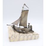 A miniature silver model of a boat mounted on a section of elephant tooth. 11.5 cm high.