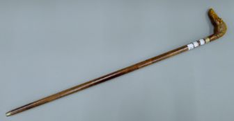A walking stick, the handle formed as a dog's head. 93 cm long.