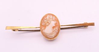 A 9 ct gold cameo bar brooch. 5.5 cm long. 2.9 grammes total weight.