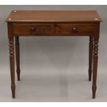 A Victorian mahogany two drawer side table. 86 cm wide, 47.5 cm deep, 76.5 cm high.