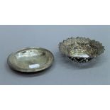 A pierced silver bon bon dish and another small silver dish. The former 12 cm diameter. 117.