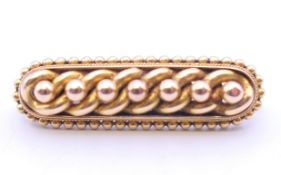 A 15 ct gold brooch. 3.75 cm long. 5.6 grammes.