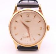 A 9 ct gold cased Longines wristwatch. 3.5 cm wide. 36.3 grammes total weight.