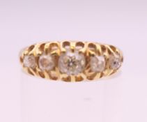 An 18 ct gold five stone diamond ring. Ring size P. 2.9 grammes total weight.
