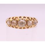 An 18 ct gold five stone diamond ring. Ring size P. 2.9 grammes total weight.