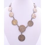 A necklace formed from various coins. 40 cm long.