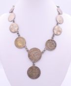 A necklace formed from various coins. 40 cm long.