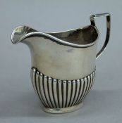 A silver cream jug. 9 cm high. 115.2 grammes.