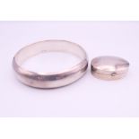 A silver pill box and a silver bangle. Bangle 6.5 cm internal diameter.