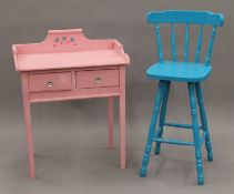 A pink painted two drawer dressing table and a blue painted high stool. The former 69 cm wide.