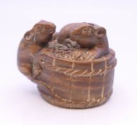 A netsuke formed as rats on a basket. 3 cm high.