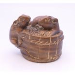 A netsuke formed as rats on a basket. 3 cm high.