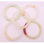 Five various jade bangles. Approximately 6 cm internal diameter.