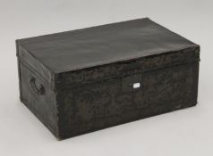 A 19th century Chinese black leather trunk with flower decoration and brass fittings. 58 cm wide.