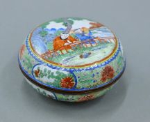 An antique Chinese enamel circular box, the underside with six character mark. 7.5 cm diameter.