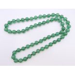 A string of jade beads. 68 cm long.