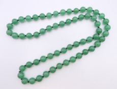 A string of jade beads. 68 cm long.