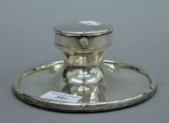 A large silver Capstan inkwell with inset gentleman's pocket watch to the lid,