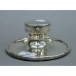 A large silver Capstan inkwell with inset gentleman's pocket watch to the lid,