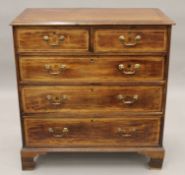 A George III later geometrically line inlaid crossbanded chest of drawers. 100 cm wide.